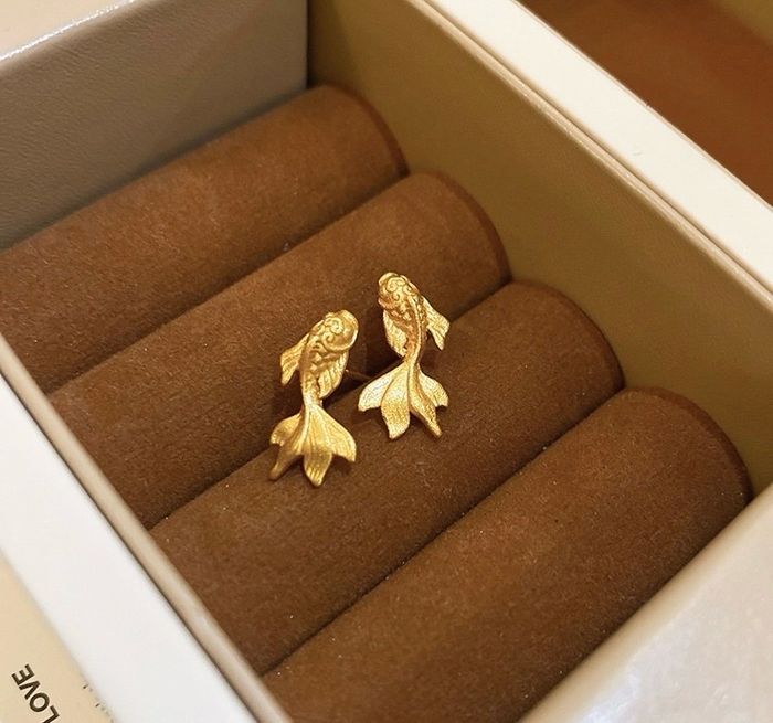 A pair of gold-plated brass Koi Fish earrings with a matte finish, elegantly displayed in a white jewelry box, symbolizing luck for the Lunar New Year.