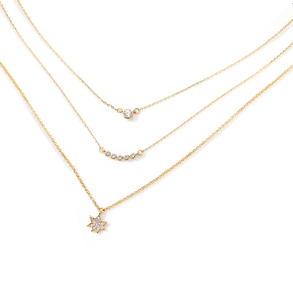 Detailed view of the Star Layer Necklace, showing three delicate gold chains with various diamond and star-shaped cubic zirconia pendants.