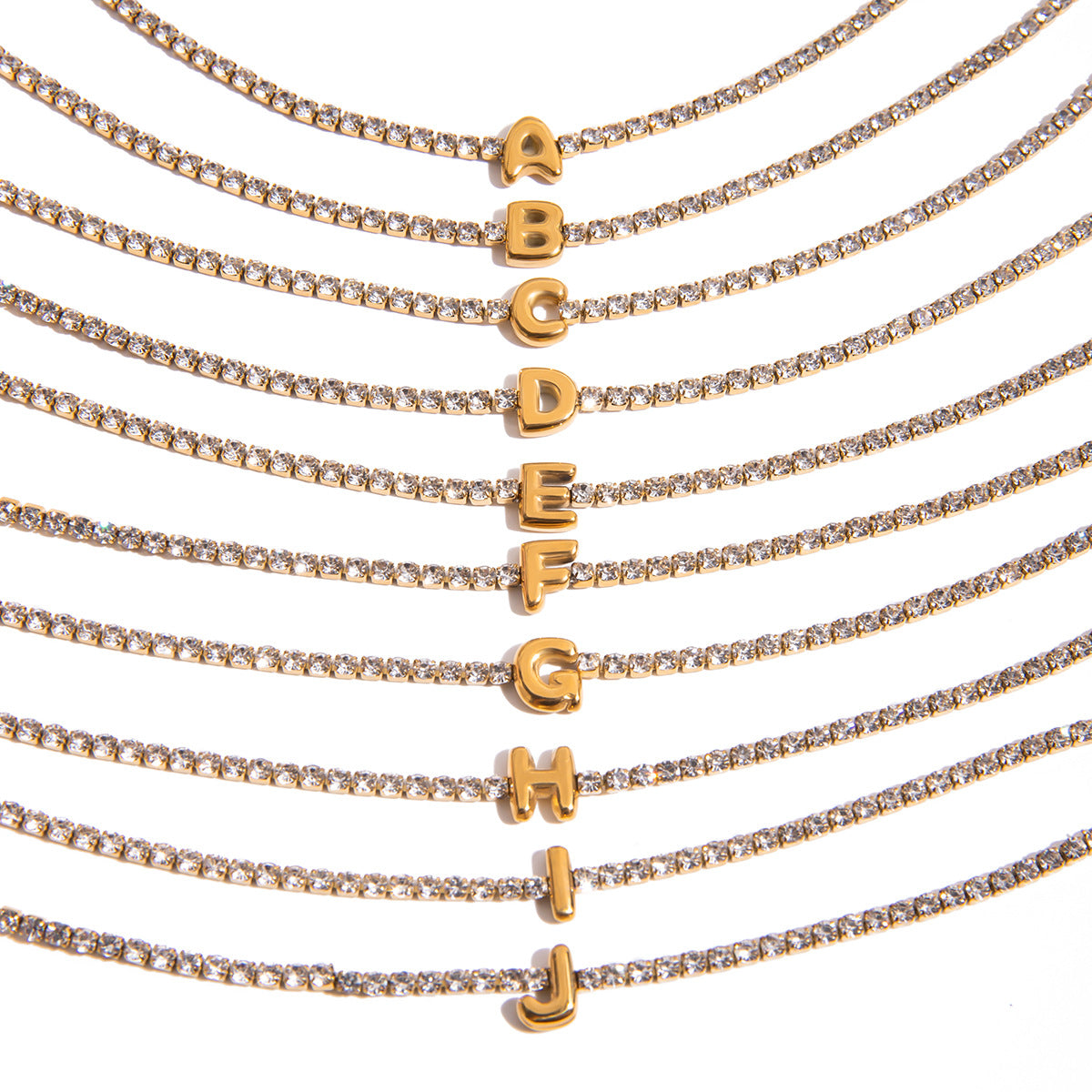 A collection of wholesale 18K gold-plated stainless steel initial bracelets, displaying letters from A to J, perfect for personalized name jewelry sets.
