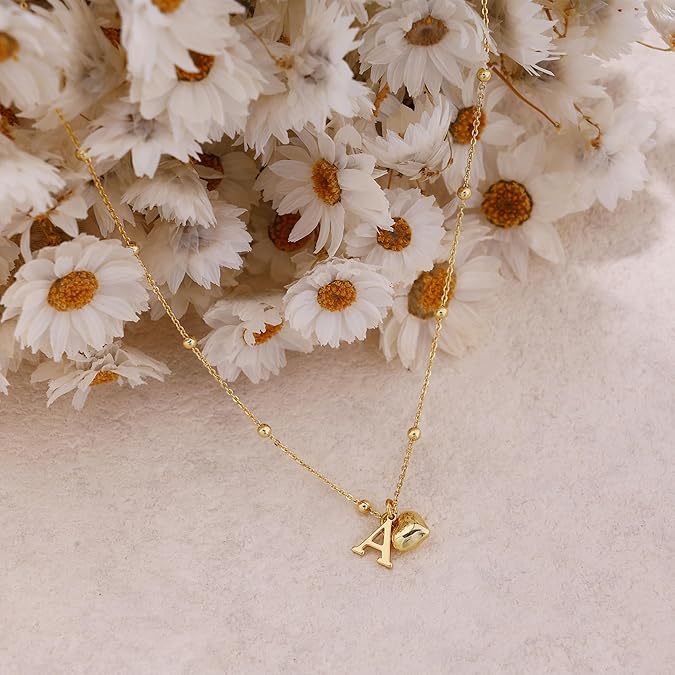 A 14K gold plated heart necklace featuring a customizable 'A' initial pendant, presented against a clean white background.