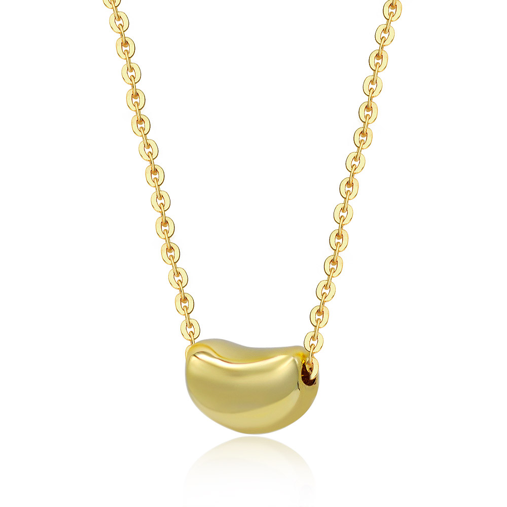 Close-up of the Luscious Gold Bean Necklace, showing the polished gold-plated bean-shaped pendant on its delicate chain.