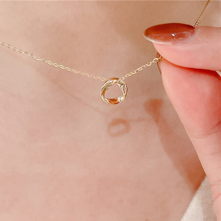 A 925 sterling silver necklace with a gold-plated twisted Mobius circle pendant, displayed on a neutral background.
