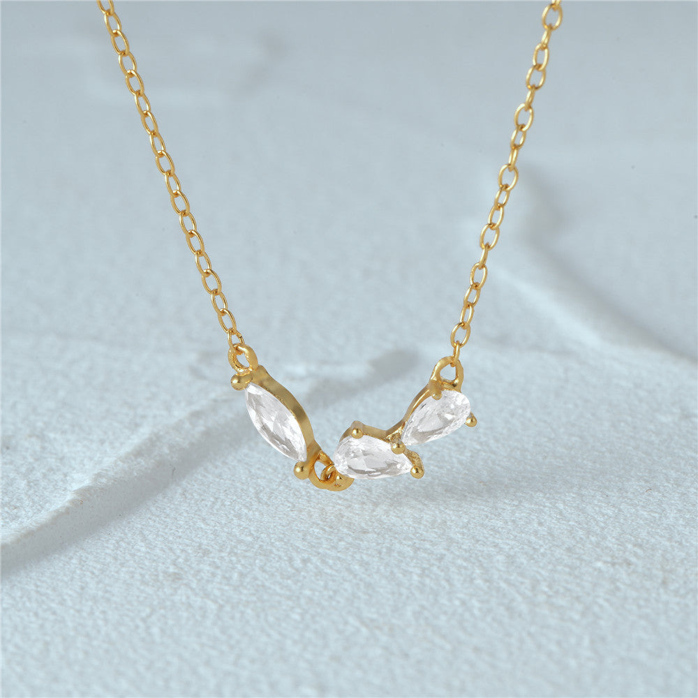 A close-up of the 925 silver geometric cluster zircon necklace in a radiant gold finish, showcasing the sparkling crescent-shaped pendant.