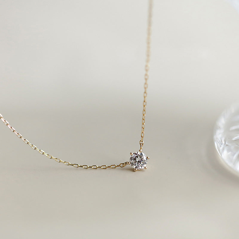A close-up of a 925 sterling silver solitaire stone pendant necklace with a gold finish, displayed on a clean white background.