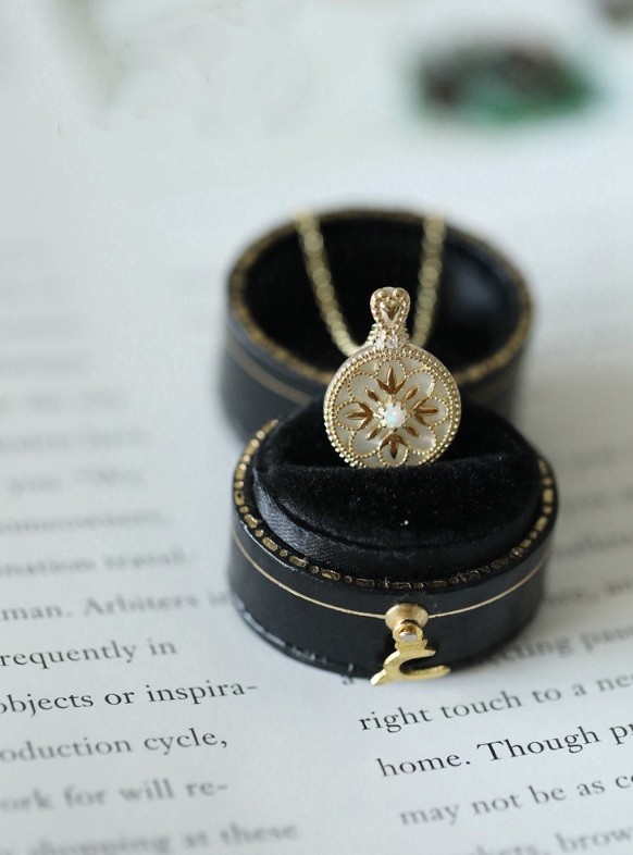 A beautiful 925 Sterling Silver Opal Round Necklace with gold plating, featuring a delicate flower-like pendant with an opal center.