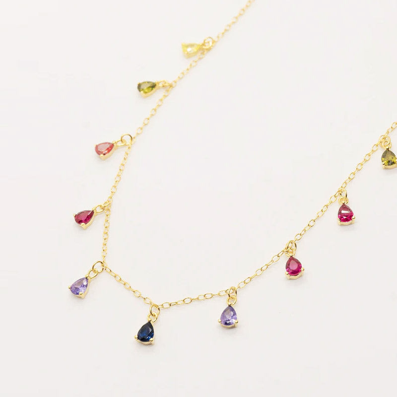 A close-up of the 925 Sterling Silver Rainbow Dangling Teardrop Necklace, showcasing its gold chain and vibrant, multicolored gemstones.