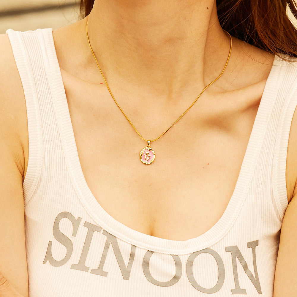 A model wearing the elegant stainless steel 18K gold plated flower pendant necklace, showcasing its delicate design and fit.