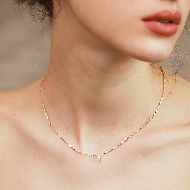 A woman wearing the elegant 925 sterling silver necklace with a marquise zircon stone charm, showcasing its gold-colored finish.