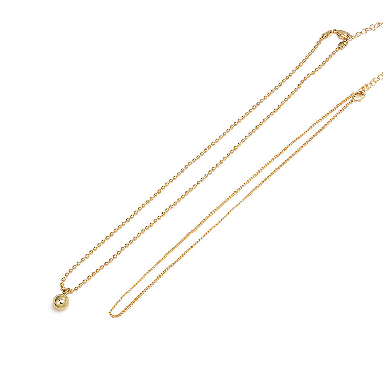Close-up of the Double Chain Layered Mini Ball Necklace, showing the spherical pendant and delicate chain details.