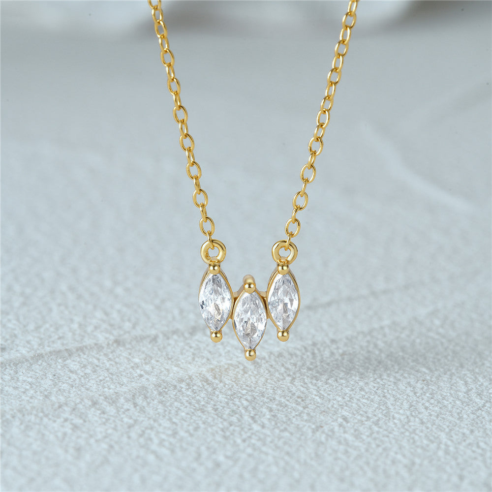 A close-up of the 925 Sterling Silver Three Micro-Set Zircon Collar Necklace, showcasing the three sparkling gemstones on a gold-plated chain.