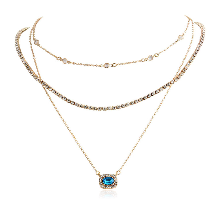 A stunning collection of three layered gold necklaces with assorted blue and clear gemstone pendants, showcasing the custom design capabilities of JR Fashion Accessories.