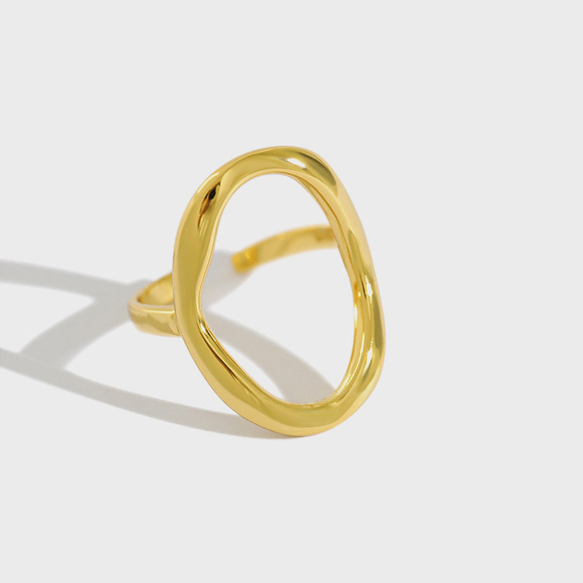 Close-up of a minimalist 925 silver open oval ring with a polished 18K gold plating, shown on a clean white background.