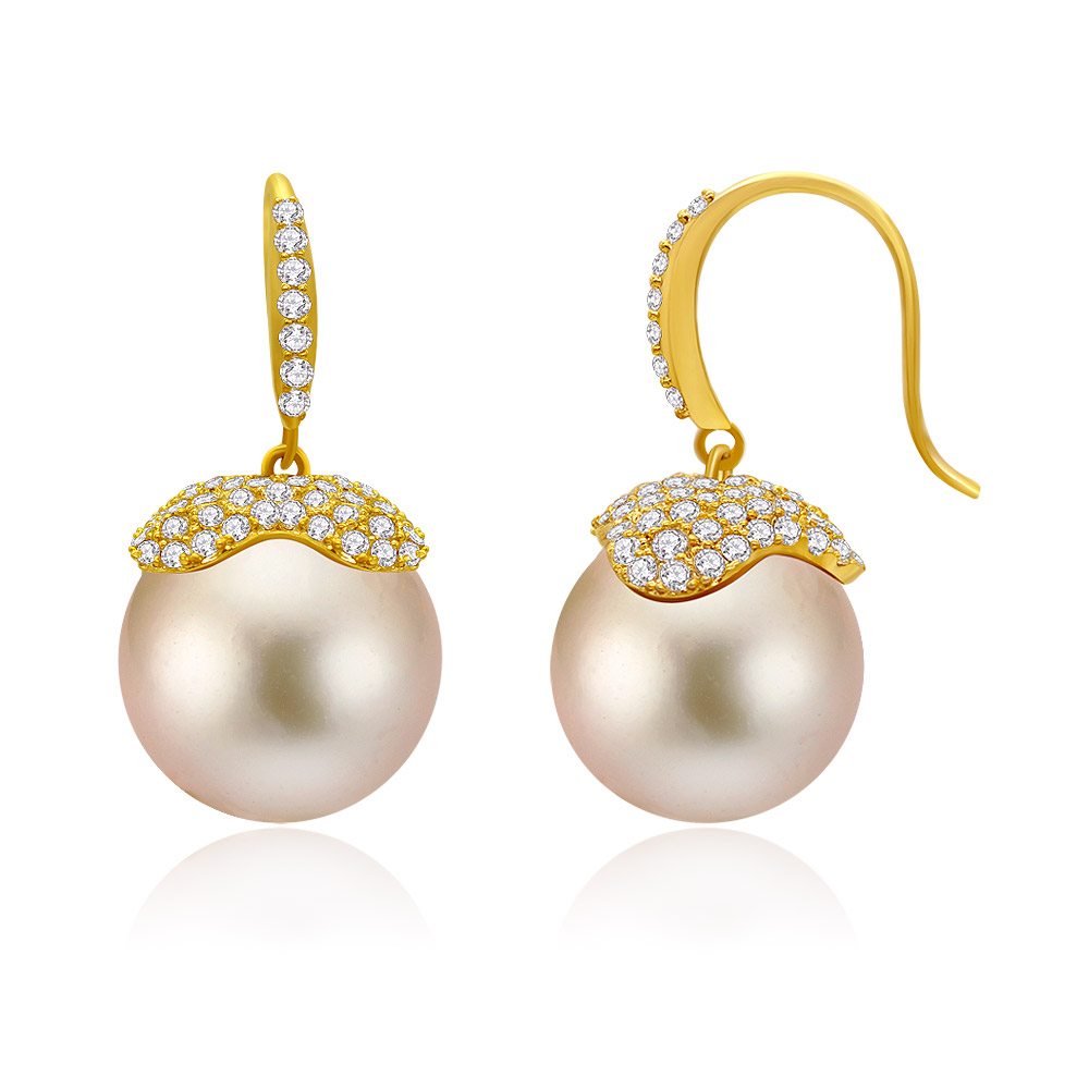A close-up of the Champ Pearl Drop Hook Earrings, showcasing the lustrous champagne-colored pearl, sparkling cubic zirconia accents, and elegant gold-plated hook.
