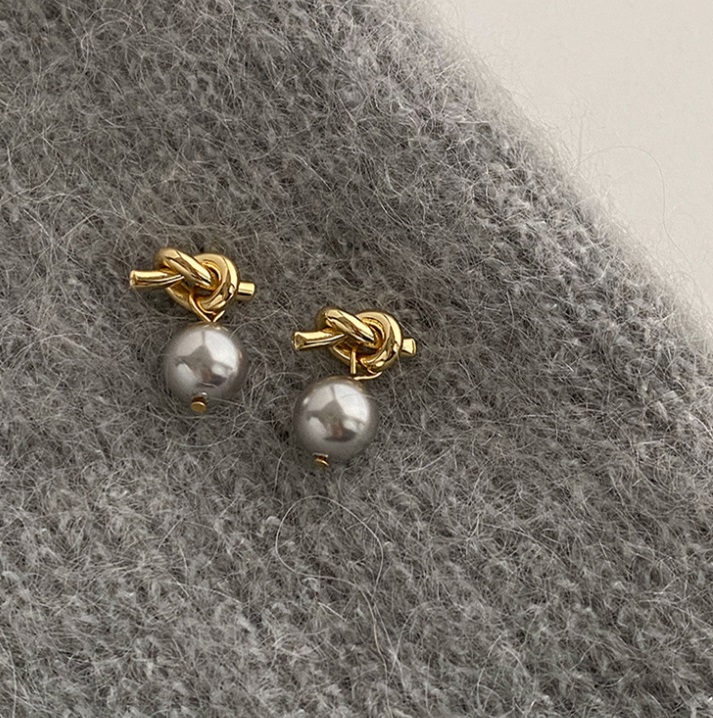 A pair of 925 Sterling Silver Knotted Pearl Earrings with an elegant gold-plated finish, showcasing the lustrous pearls.