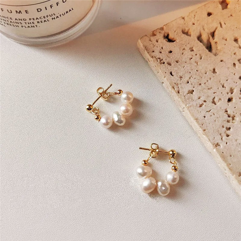 A pair of 14K gold plated baroque freshwater pearl beaded stud earrings on a clean white background.