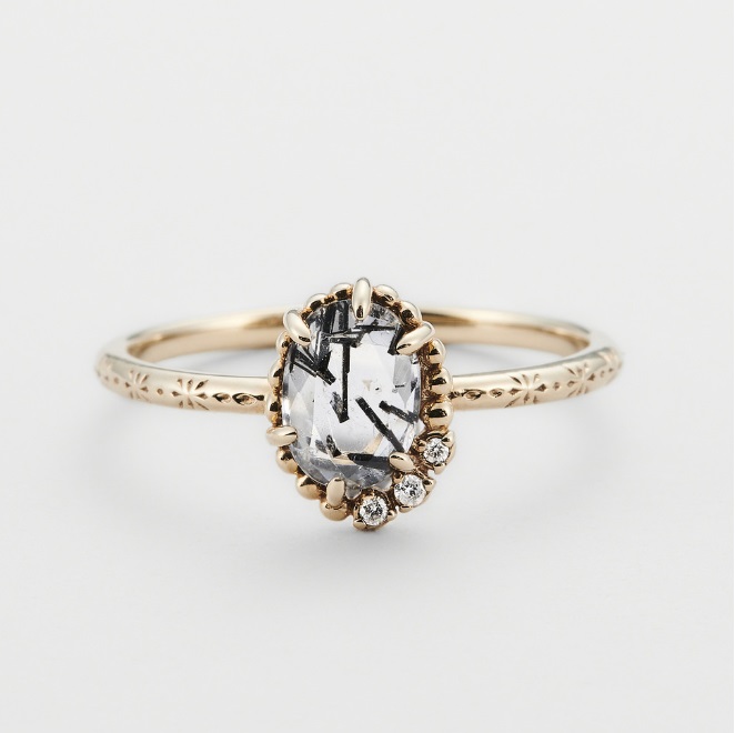 Close-up of a 925 Sterling Silver Salt and Pepper Gem Stone Ring with a gold finish, showcasing the intricate floral pattern etched on the band and the unique inclusions within the central gemstone.