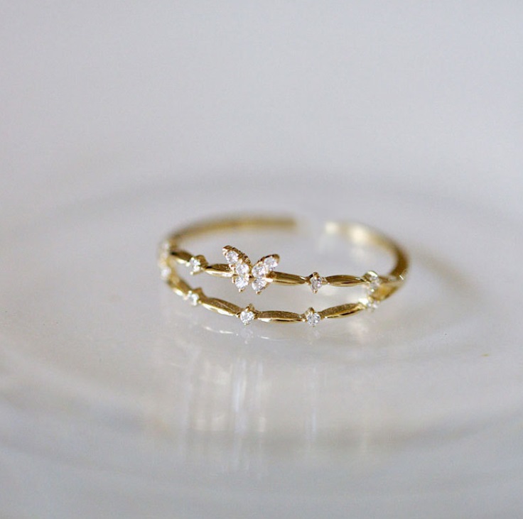 A close-up of the 925 Sterling Silver Adjustable Butterfly Ring in a gold finish, highlighting the detailed butterfly design and sparkling cubic zirconia stones.