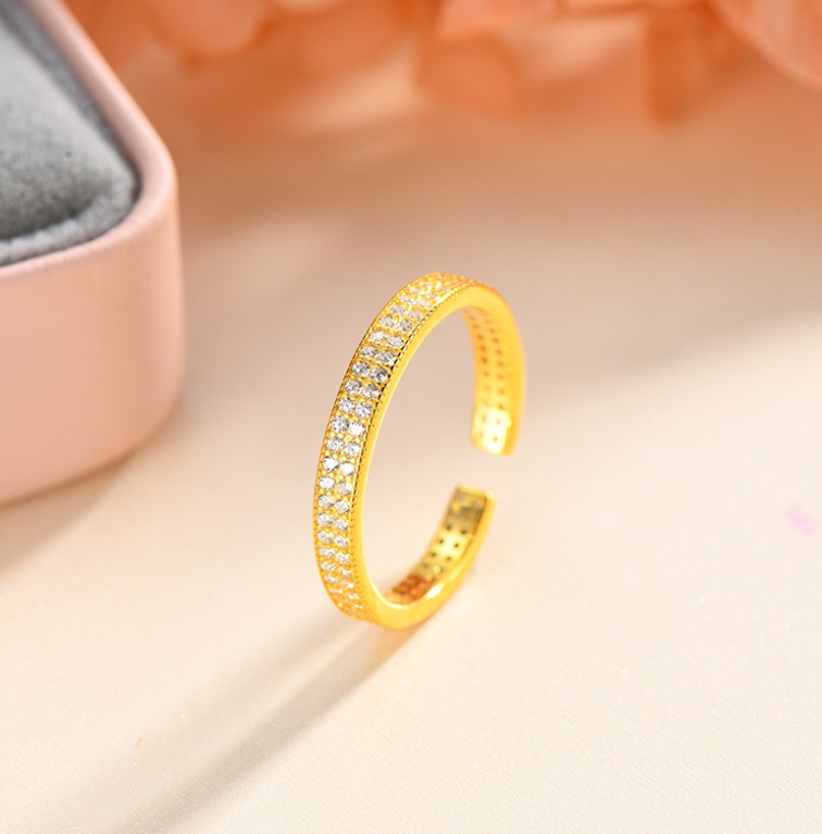 A detailed studio photograph of the 925 Sterling Silver Micro Pave CZ Adjustable Band Ring, highlighting the intricate micro pave setting with sparkling cubic zirconia stones on a gold-plated band.