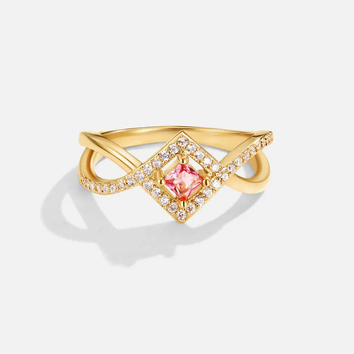 A close-up of the 925 sterling silver ring with 18K gold plating, featuring a central pink square-cut zircon surrounded by sparkling diamond-like zircons.