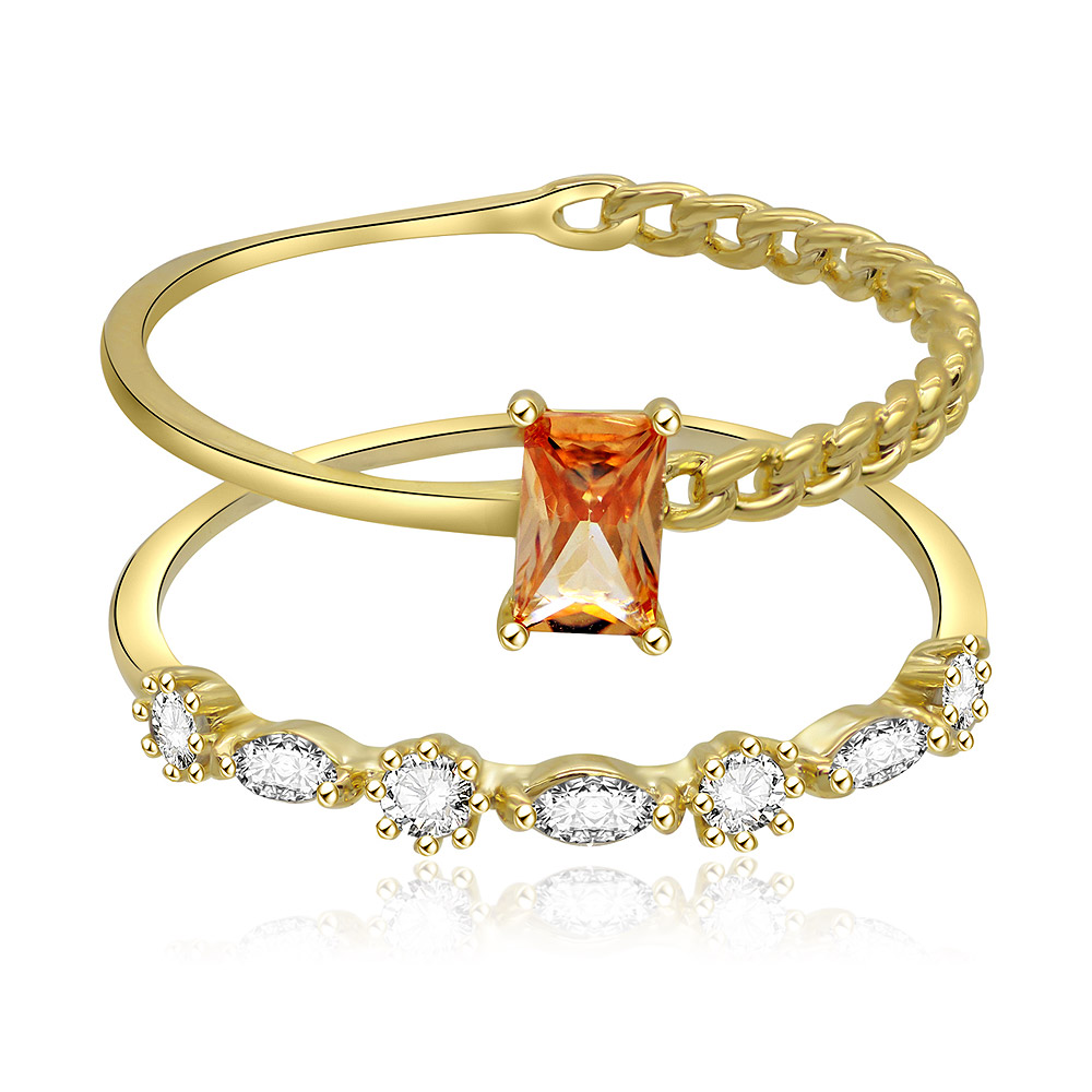 A stylish 2-piece stackable ring set in gold-plated brass, one ring featuring a champagne-colored stone and the other adorned with clear white cubic zirconia.