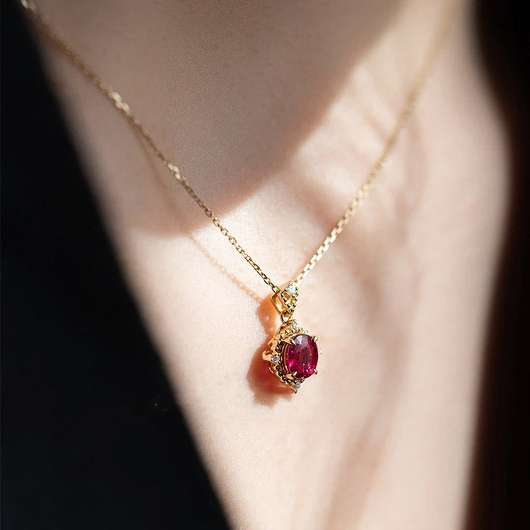 Close-up of a 925 sterling silver necklace with an 18K gold-plated vintage ruby pendant, highlighting the brilliant red gemstone and classic design.
