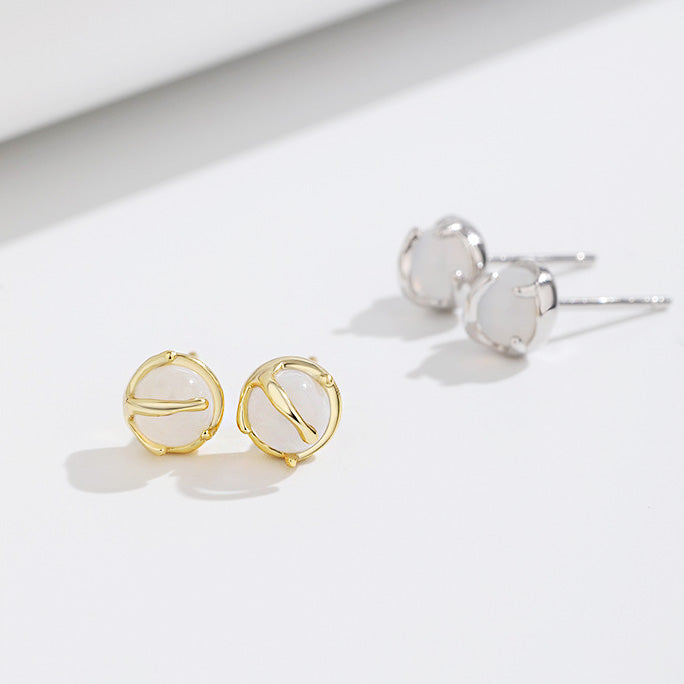 A pair of 925 sterling silver and a pair of gold-plated small round stud earrings with white agate stones, showcasing the available color options.