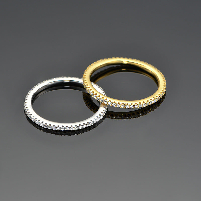 A set of 925 sterling silver CZ eternity band rings, showcasing both the gold-tone and platinum-plated silver options side-by-side.
