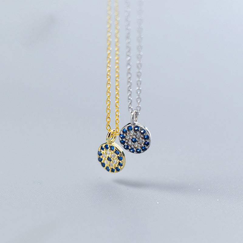A pair of 925 sterling silver evil eye choker necklaces, one in a gold finish and one in a silver finish, each featuring a circular pendant with blue and white cubic zirconia stones.
