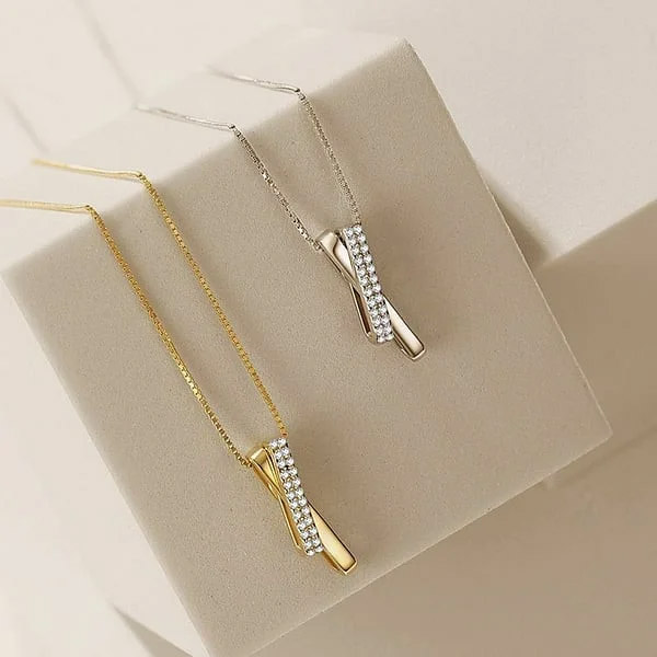 A 925 Sterling Silver Cross Necklace shown in both silver and gold finishes, adorned with brilliant cubic zirconia stones.