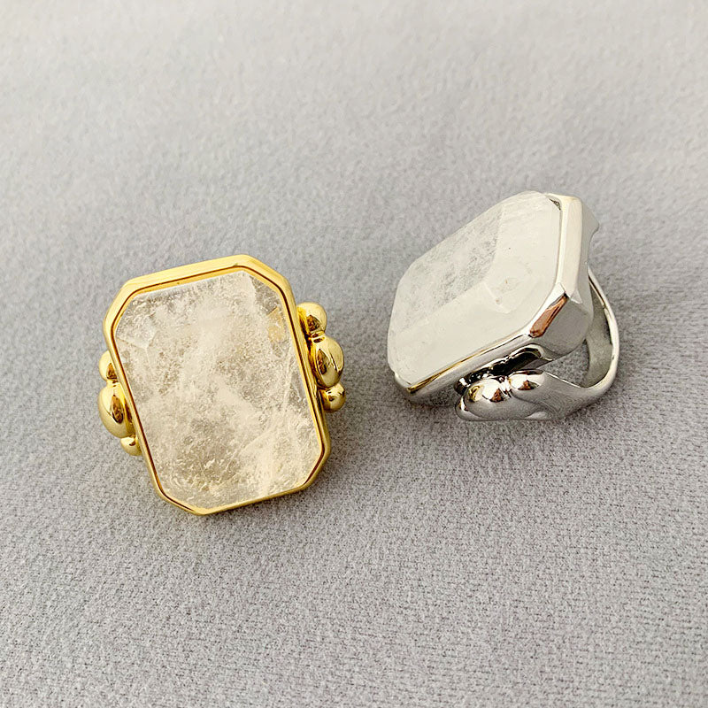 A set of vintage-style brass rings with large square transparent crystals, shown in both gold and silver finishes.