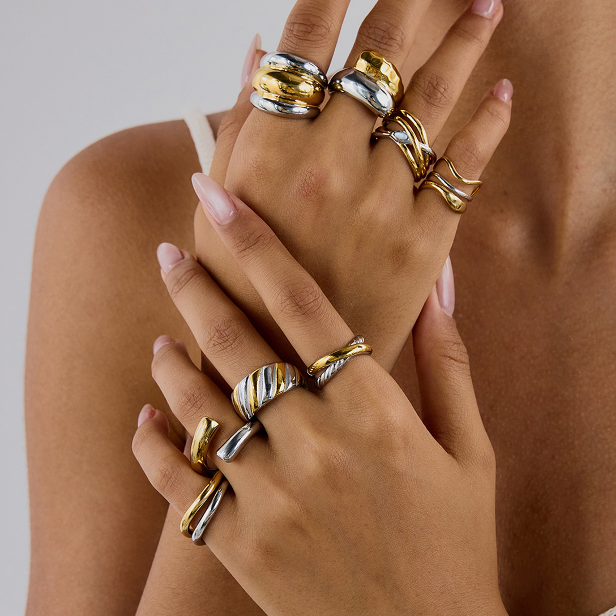 A stylish collection of PVD gold and silver plated stainless steel stackable rings from JR Fashion Accessories, displayed elegantly.