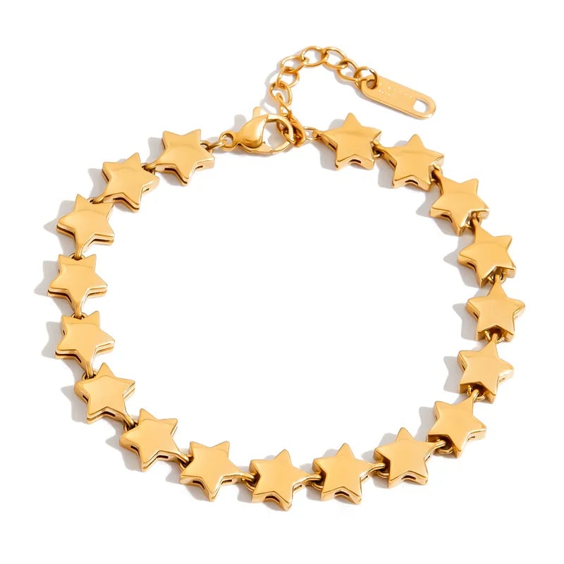 Detailed view of the wholesale gold star bracelet in stainless steel, showing the chain links, star charm, and lobster claw clasp.