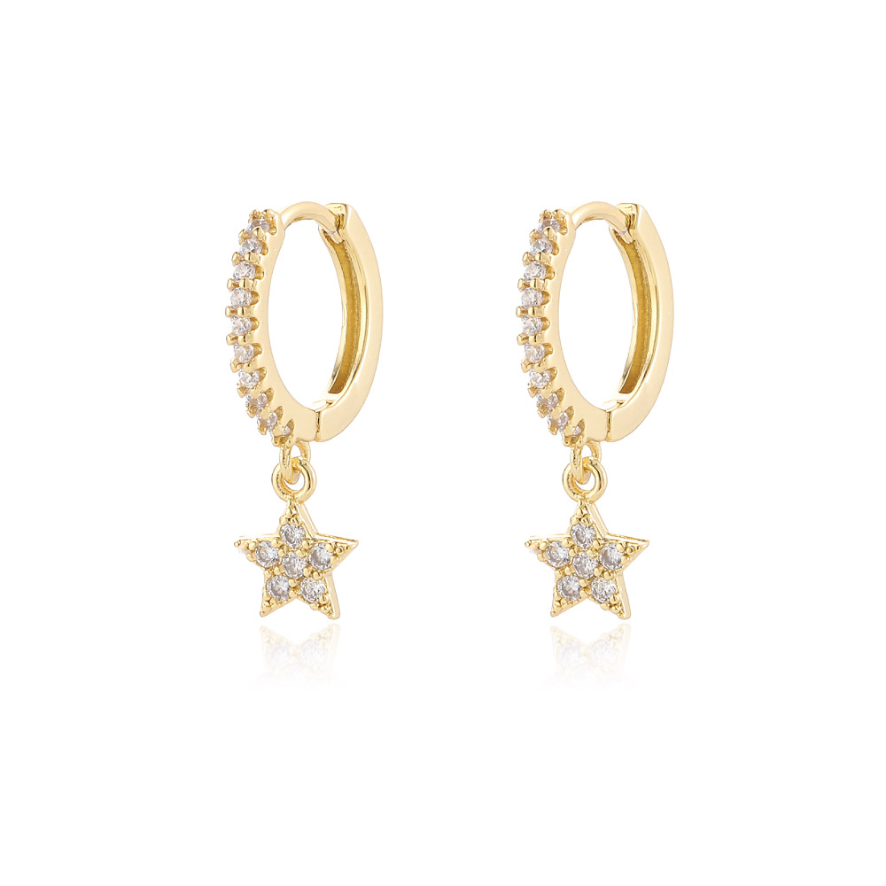 A pair of wholesale celestial drop huggie hoop earrings in gold, featuring star-shaped charms encrusted with sparkling cubic zirconia diamonds.