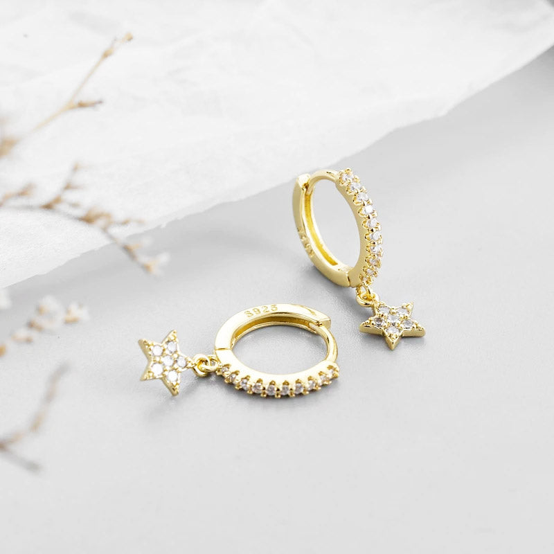 Close-up of the 925 Sterling Silver Celestial Pavé Star Hoop Earrings in a gold finish, highlighting the intricate pavé stone details on the star charm and the S925 stamp.
