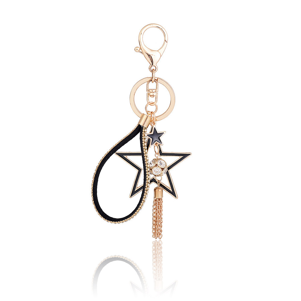 A close-up of the Bling Crystal Gold Star Key Chain, showcasing the detailed star-shaped pendant with black and gold crystals, a black PU leather strap, and a delicate gold chain tassel.