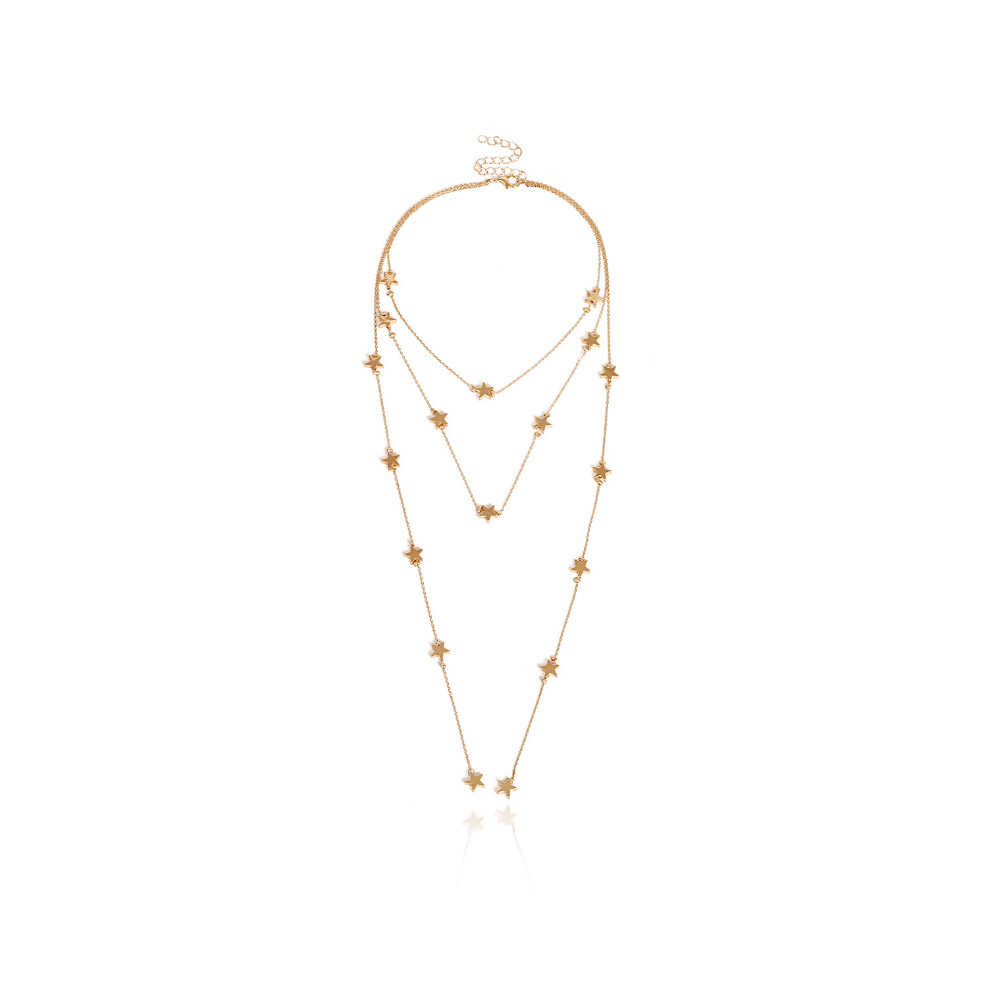 A multi-layer gold tone star necklace with delicate chains and a central star charm, displayed on a neutral background.