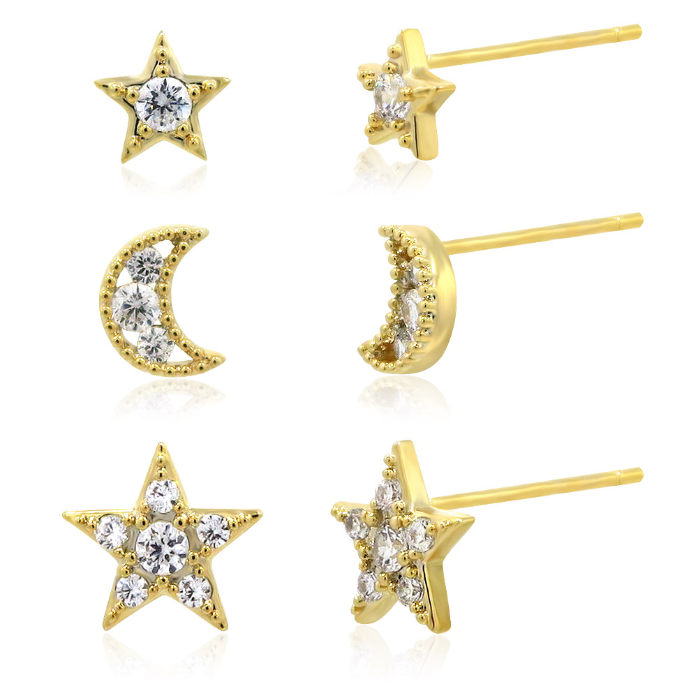 A complete set of three pairs of tiny star and moon stud earrings, crafted in 14k gold plated brass and adorned with sparkling cubic zirconia stones.