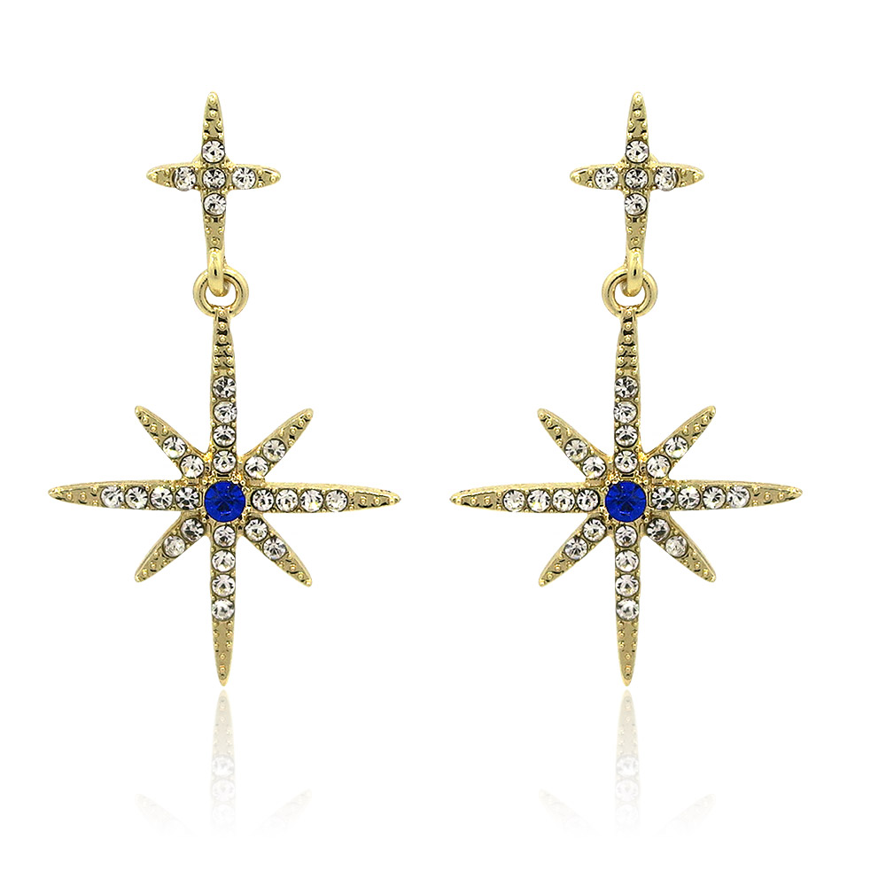 A pair of Cross Crystal Starburst Earrings, featuring a gold-tone finish with sparkling white cubic zirconia and a central blue sapphire glass stone.