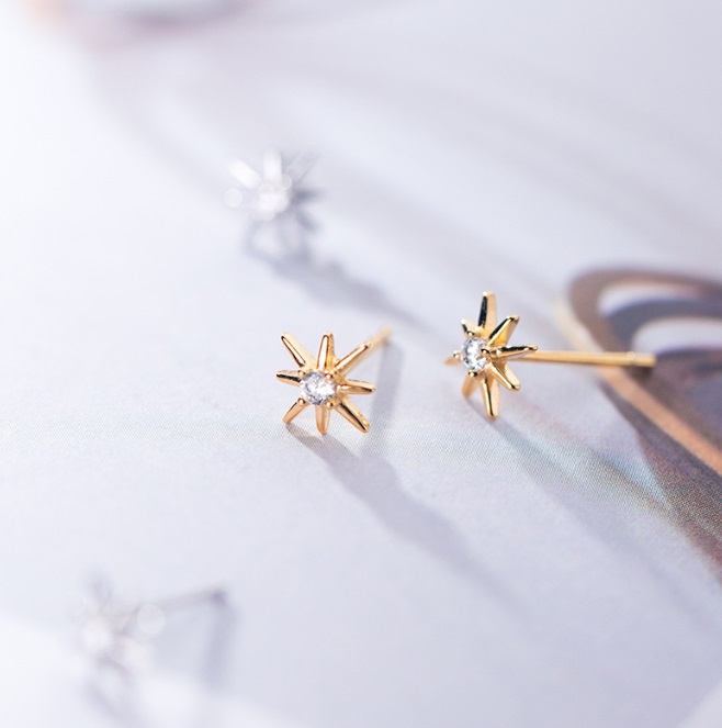 A pair of 925 Sterling Silver Starburst Earrings in a radiant gold finish, featuring a central sparkling cubic zirconia stone.