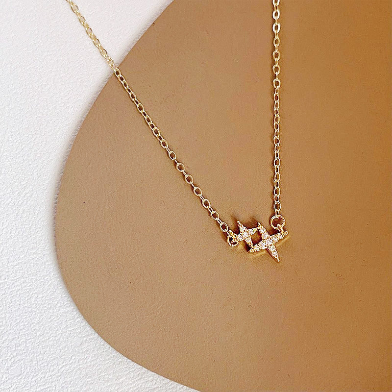 A stunning gold-plated collar necklace featuring a sparkling double-star charm with micro-insert zirconia, displayed on a clean white background.