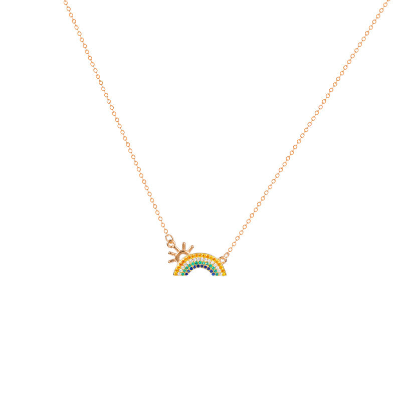 A detailed studio shot of a 925 sterling silver necklace with 18K gold plating, showcasing a colorful zircon pendant in a sun and rainbow design.