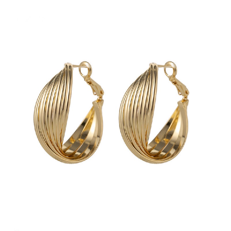 A pair of large criss-cross gold hoop earrings with a hollow, curved teardrop shape, showcasing a polished gold finish.