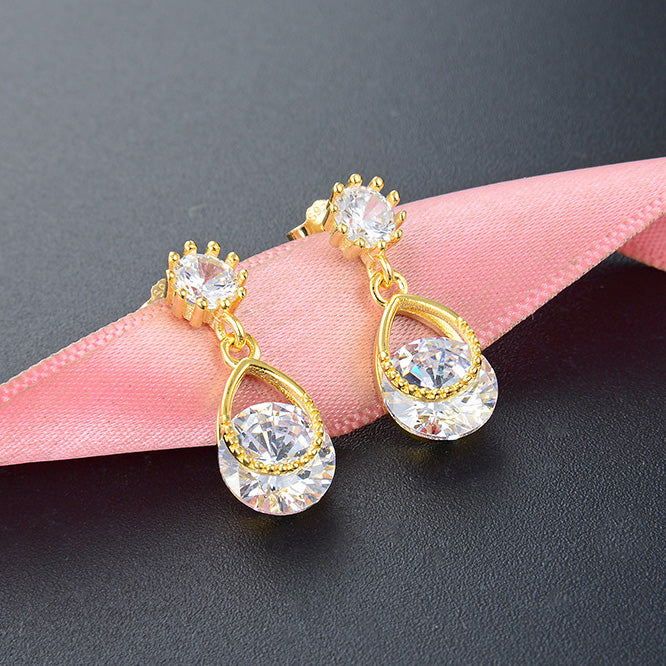 A close-up view of the 925 sterling silver gold-plated teardrop earrings, showcasing the sparkling white zirconia in a classic teardrop design.