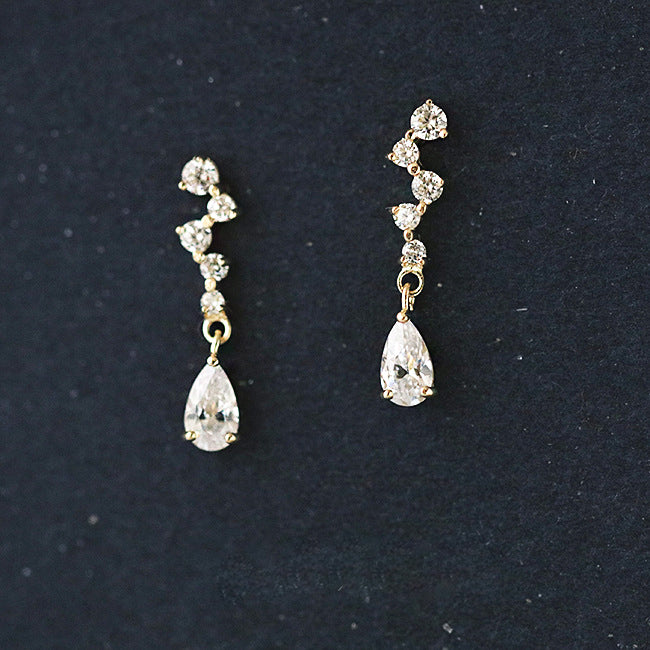 A pair of elegant 925 sterling silver drop earrings with gold plating, featuring micro-inlaid zircon stones leading to a sparkling teardrop crystal.