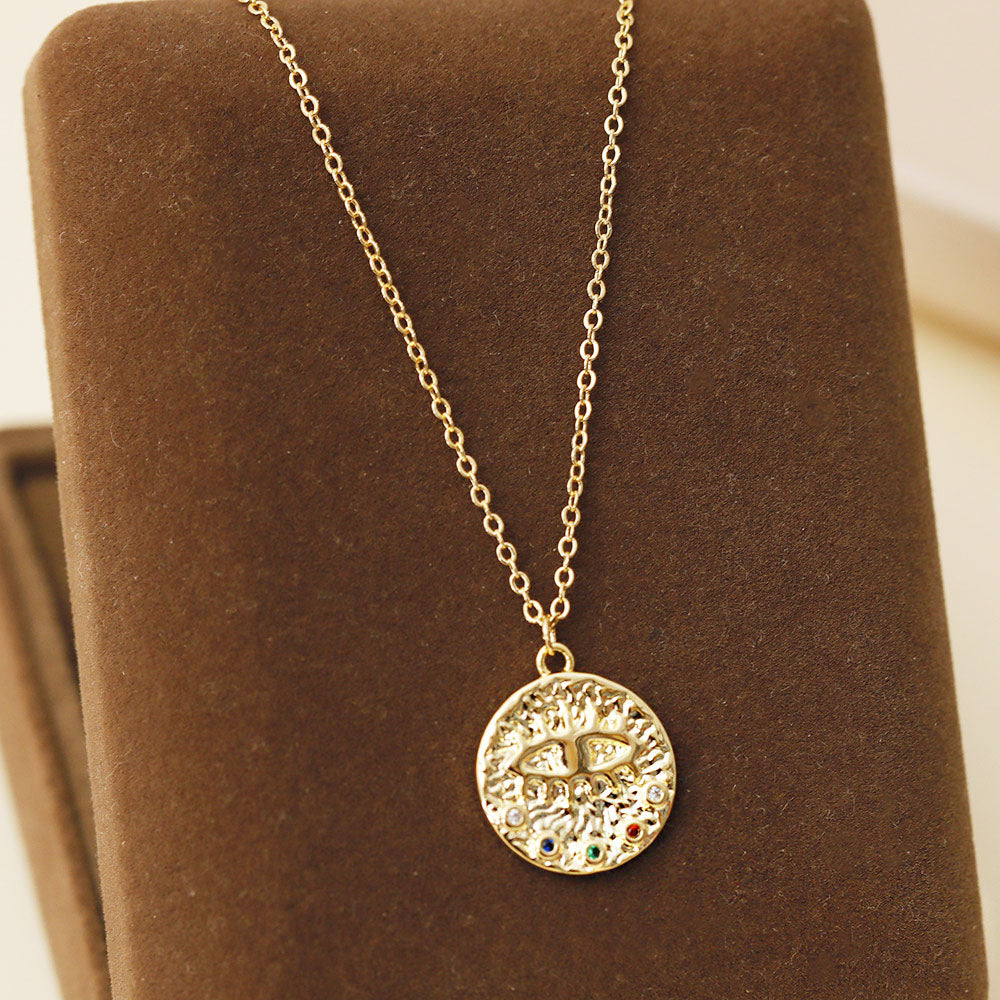 A vibrant brass evil eye pendant necklace with multi-color stones, part of a set of five from JR Fashion Accessories.