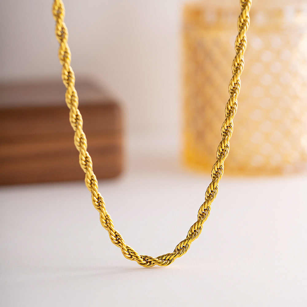 A detailed close-up of the Gold PVD Plated Stainless Steel 5mm Twisted Rope Chain Necklace, showcasing its intricate design and lustrous gold finish.