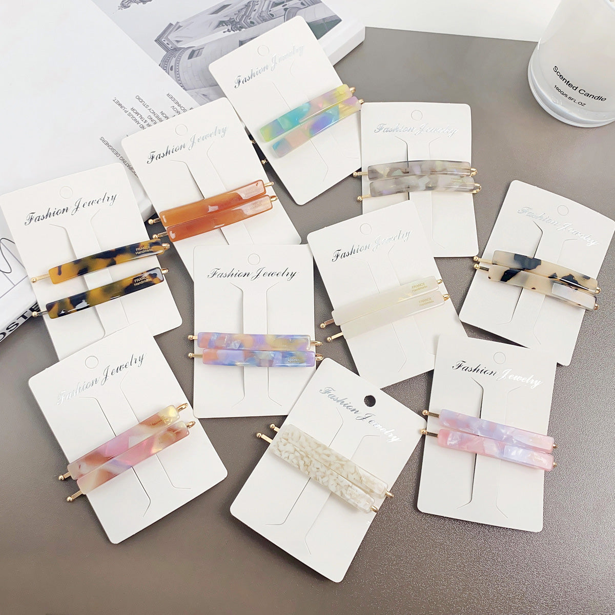 A collection of colorful acetate hair bobby pins in various styles and patterns, neatly arranged for display.