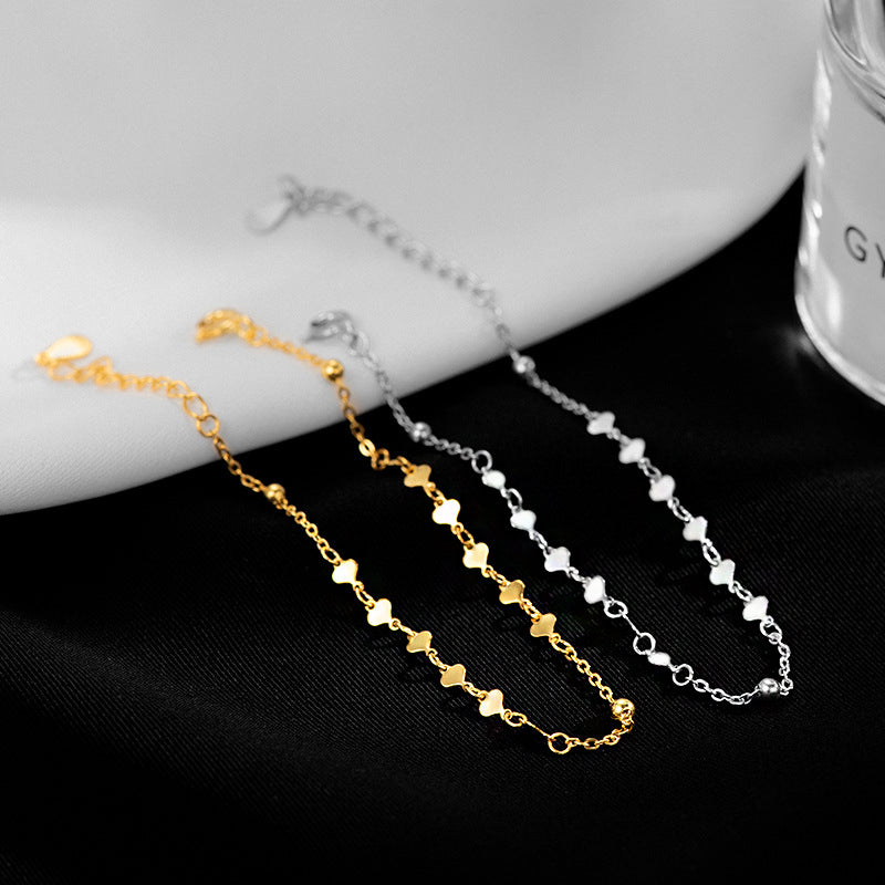A set of 925 sterling silver love heart sequin chain bracelets in both gold and silver finishes.
