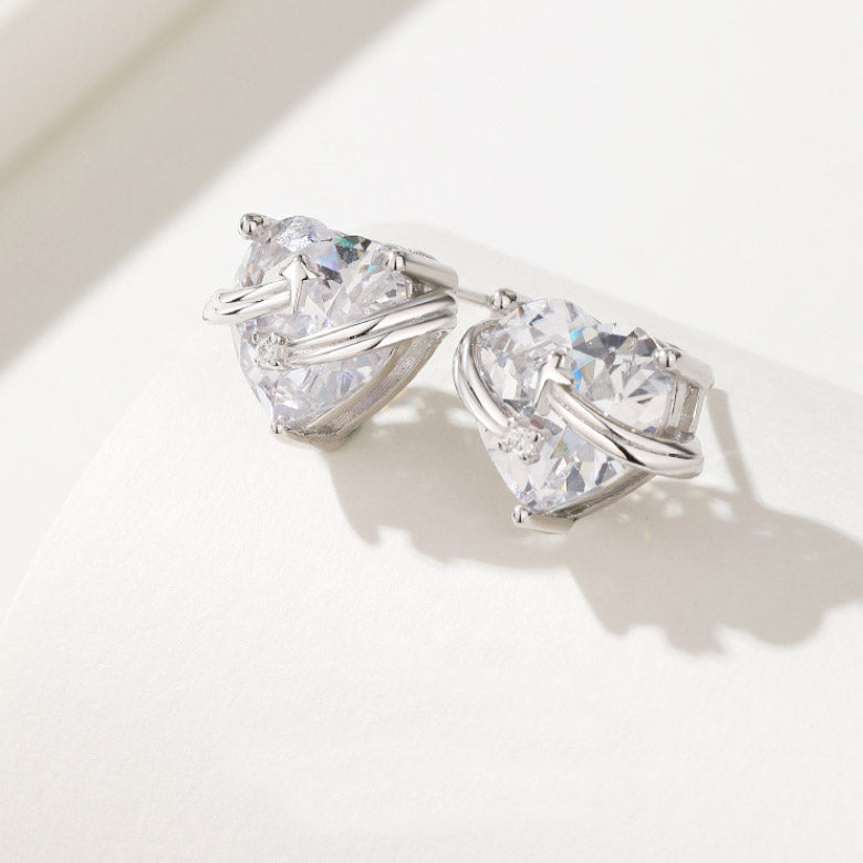 A close-up of the 925 Sterling Silver Hug Heart Zircon Stud Earrings, showcasing the brilliant faceted zircon stones set in a polished silver heart design.