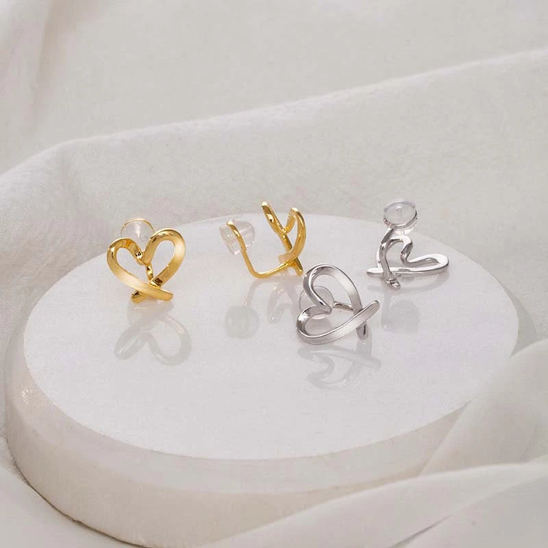 A pair of 925 sterling silver non-pierced heart ear clip earrings, showcased in both elegant gold and classic silver finishes.